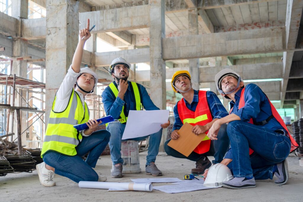 civil engineer manager meeting together with architect foreman and safety team while inspecting material of infrastructure construction progress for sustainable green building at site preparation